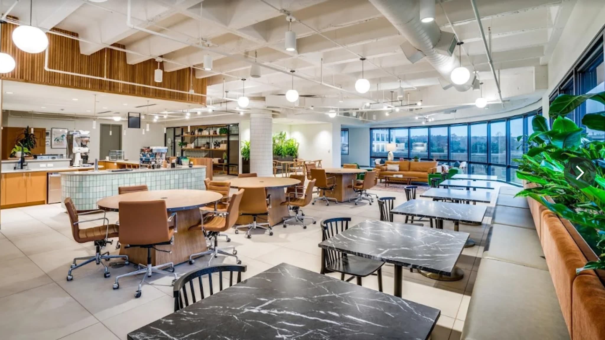 Content creators prepare compact cameras and charge lighting batteries, with a dining table in the background.
